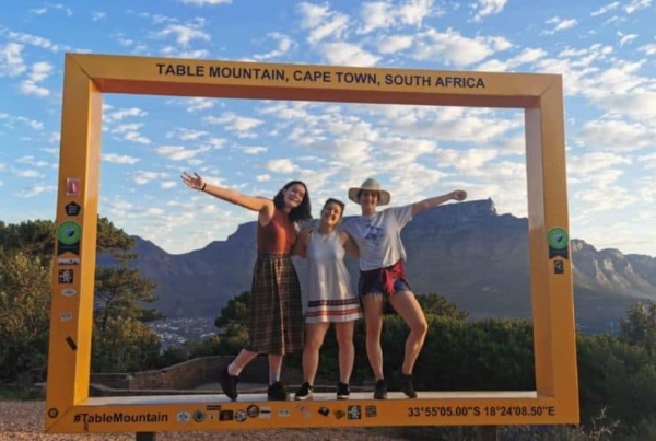 Interns posing for a picture in a make-shift frame overlooking nature.