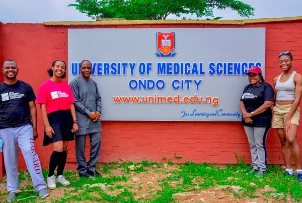 Interns standing in front of school.