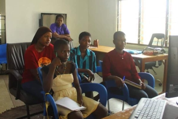 Young girls join an interactive online class in a modern learning space, embracing digital literacy and personal development tools.