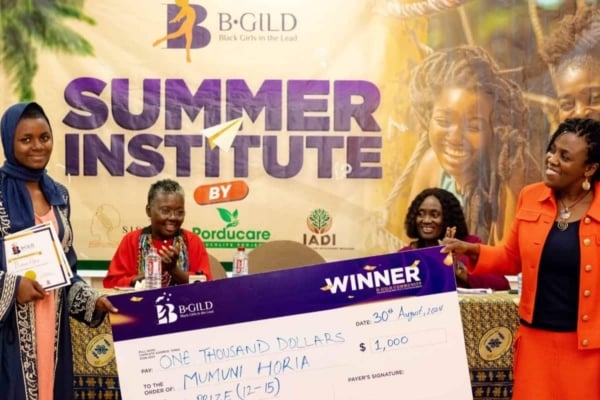 Mumuni Horia receives the B-GILD Gold Prize with a $1,000 cheque for her excellence and impact in the 12–15 age category.