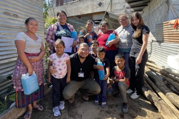 A group photo consisting of a family and interns.