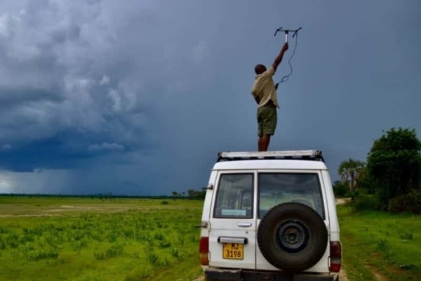Intern in Lilongwe on top of a truck trying to get a signal.