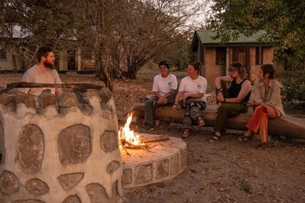 Interns in Lilongwe around a campfire enjoying each other's company.