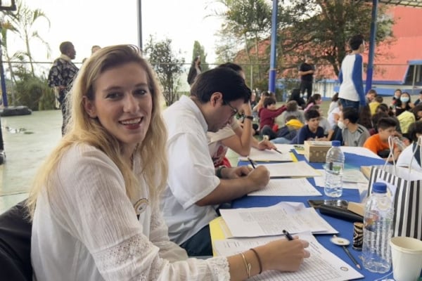Intern smiling while grading the papers of the students