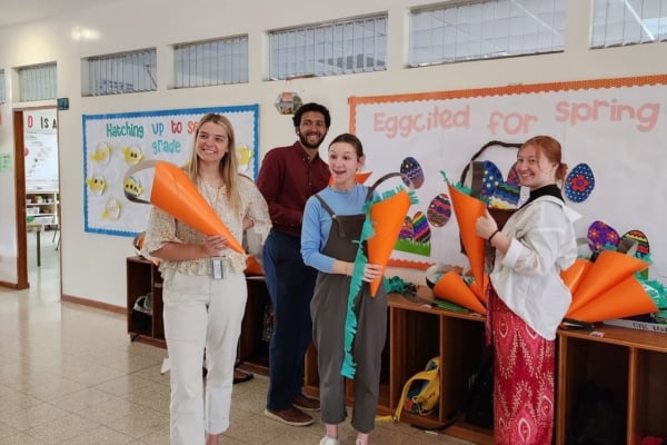 Interns posing for a picture while making arts and crafts.