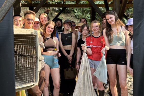A group of interns for the animal wildlife rehabilitation in Ecuador posing for a group photo.