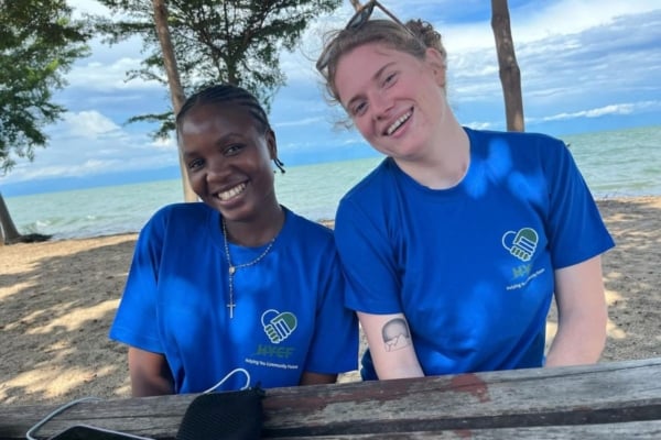 Two interns sitting on a bench in Malawi.