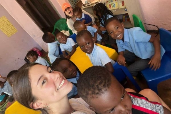 A Law & Human Rights intern enjoying the time with the kids in school.