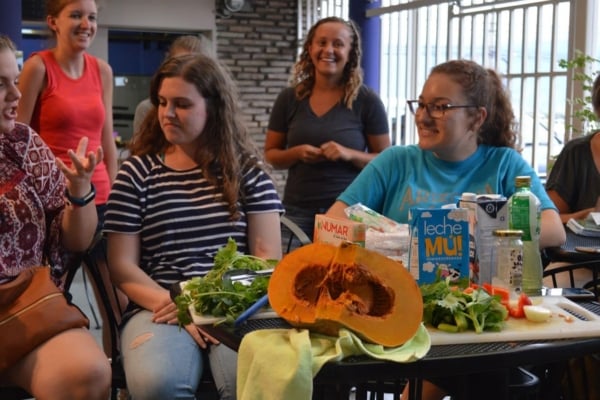Interns in Latin America enjoying preparing food together.