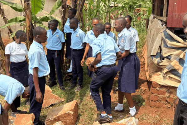 A group of students moving rocks.