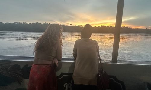 Two women looking out over a body of water.