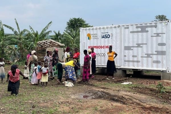 A group of people unloading a cargo container.